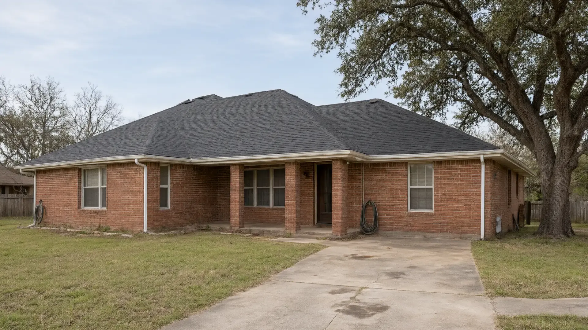 Brick ranch-style home with a new charcoal shingle roof