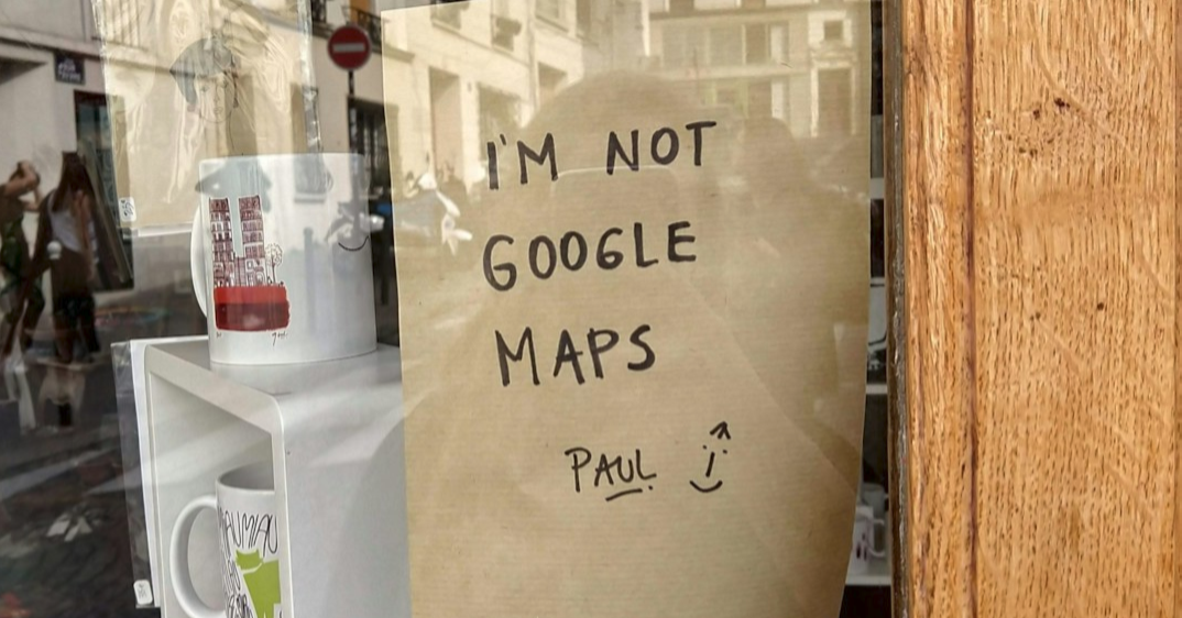 Shop window sign reading I'm not Google Maps -- why local businesses need a Google Business Profile