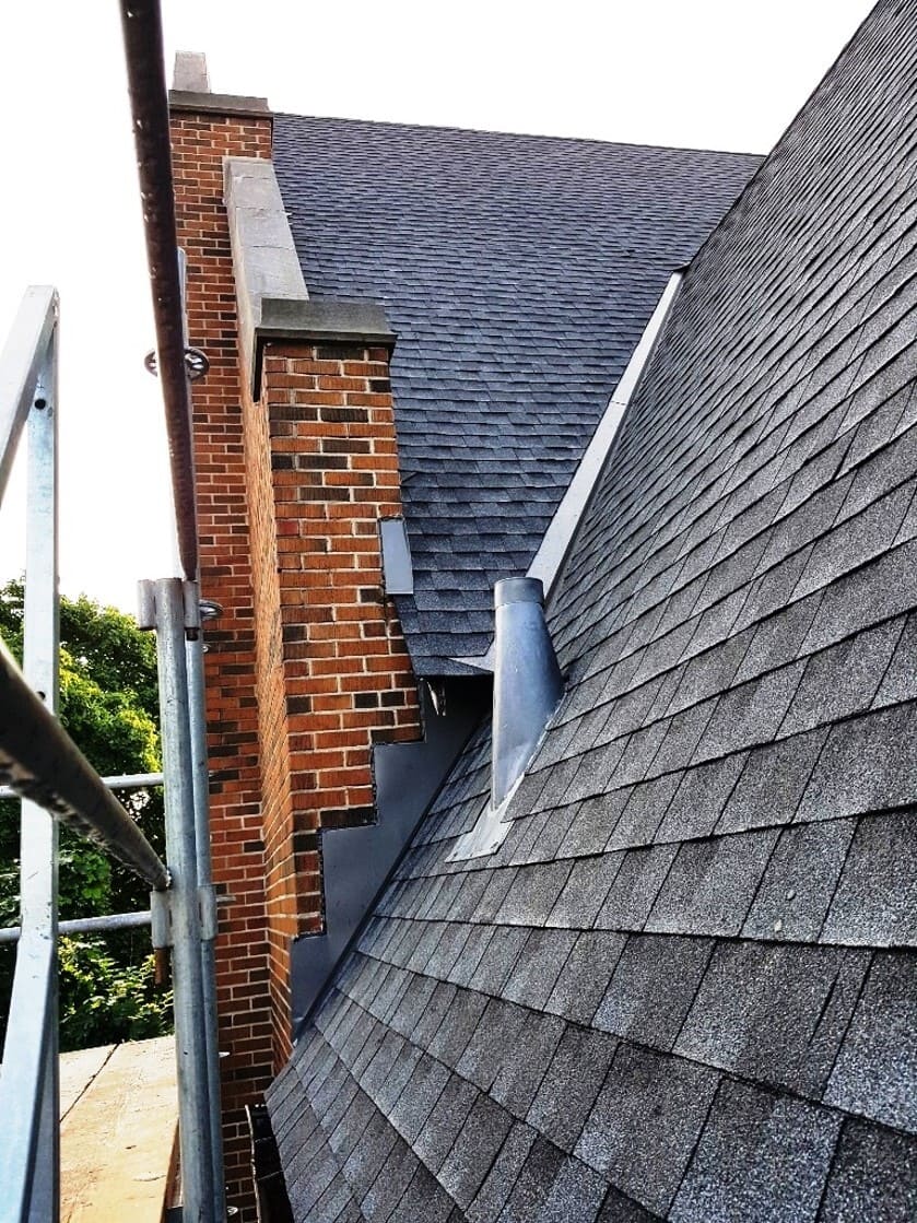 Roofing crew installing asphalt shingles on a residential roof in Toronto