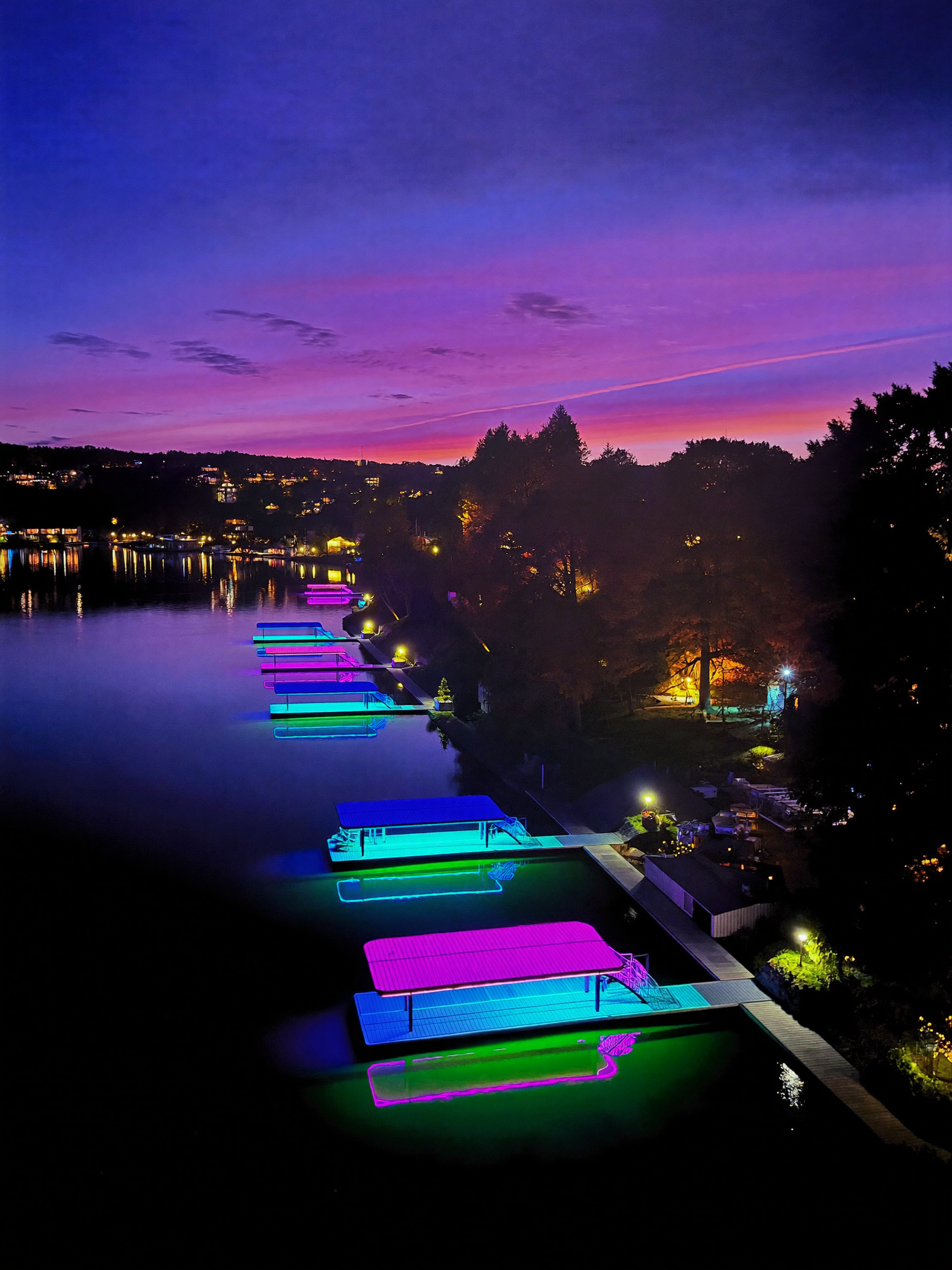 Glowing docks on a lake at night, illuminated by Luminex dock coating