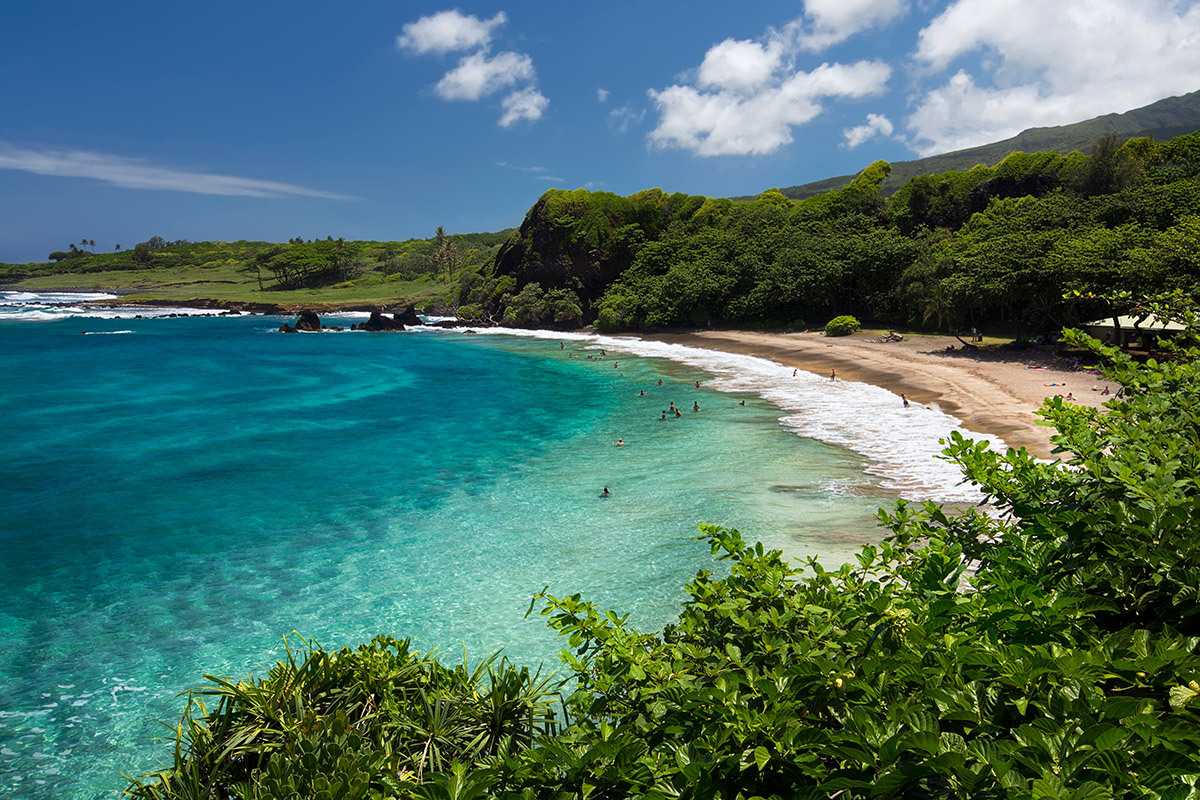 Maui beach with turquoise water and green hills