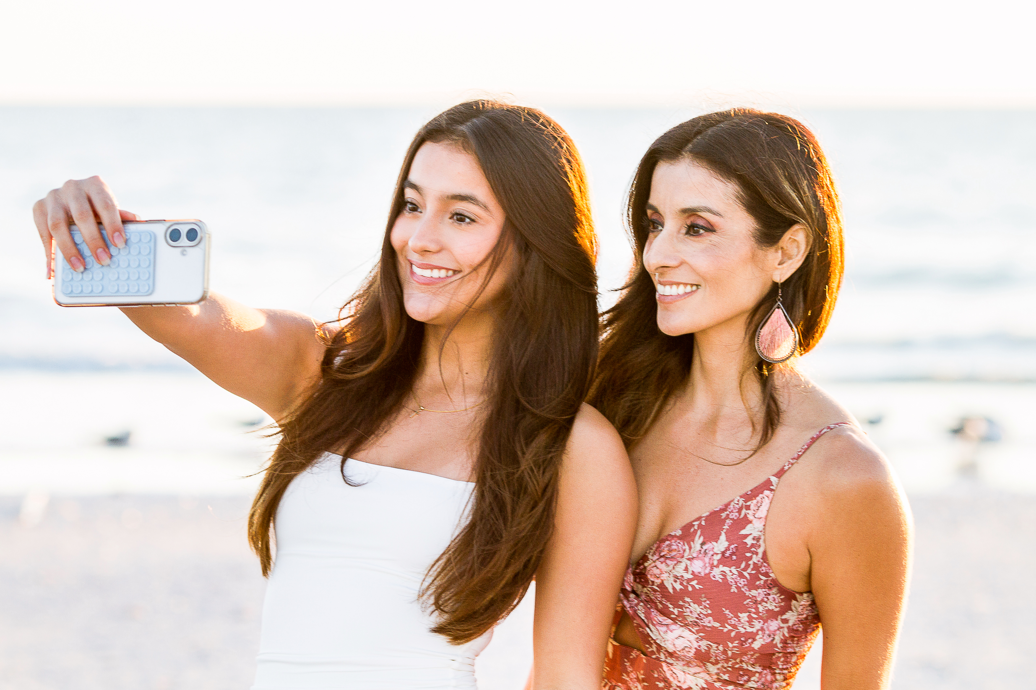 Senior taking a beach selfie with her mom