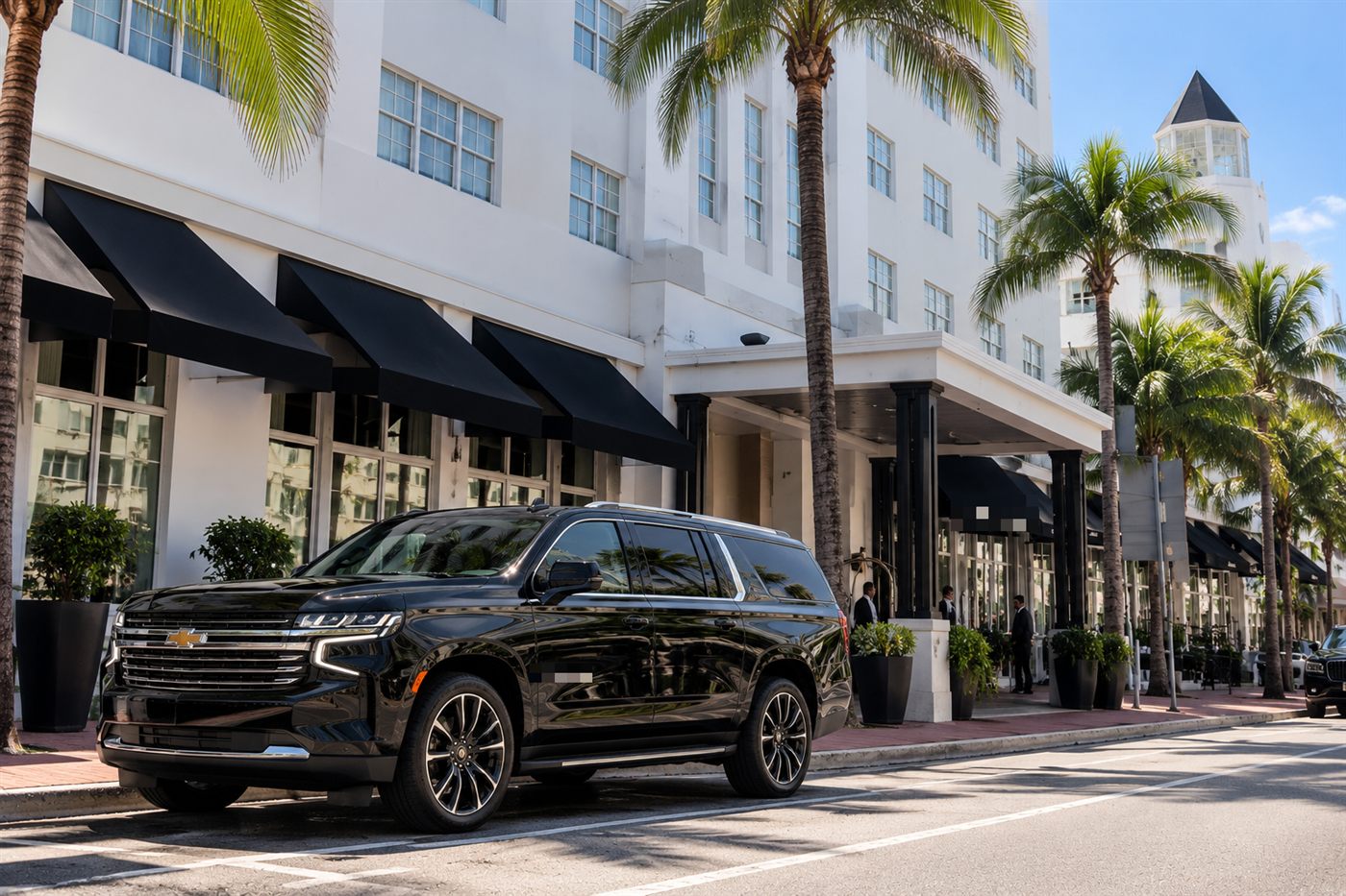 Black Chevrolet Suburban parked on Collins Avenue in South Beach on a sunny day