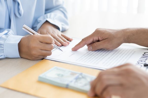 Person Signing a Contract Person Signing a Contract