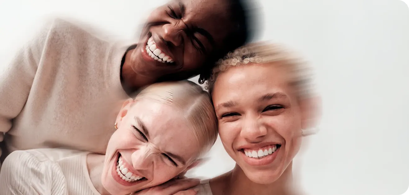 People smiling, heads leaning together