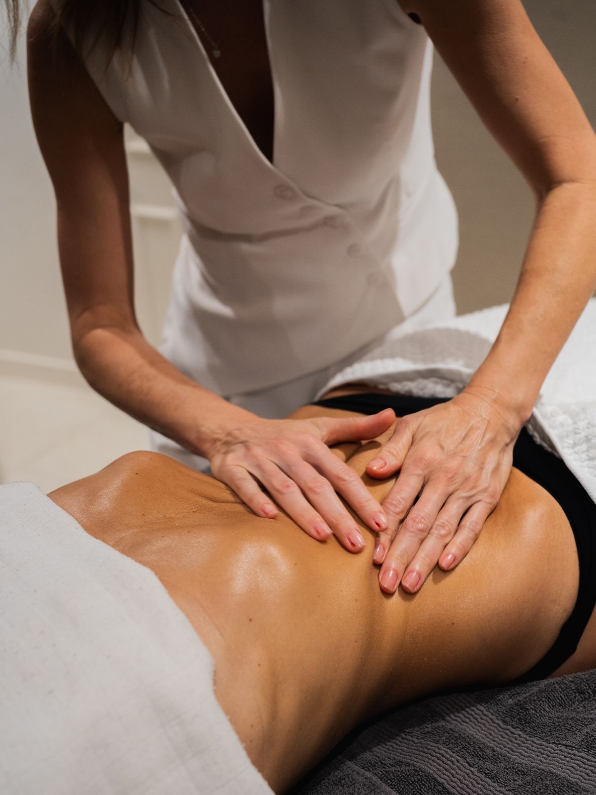 Therapist performing abdominal lymphatic drainage at The Body Temple Spa in Athens, GA