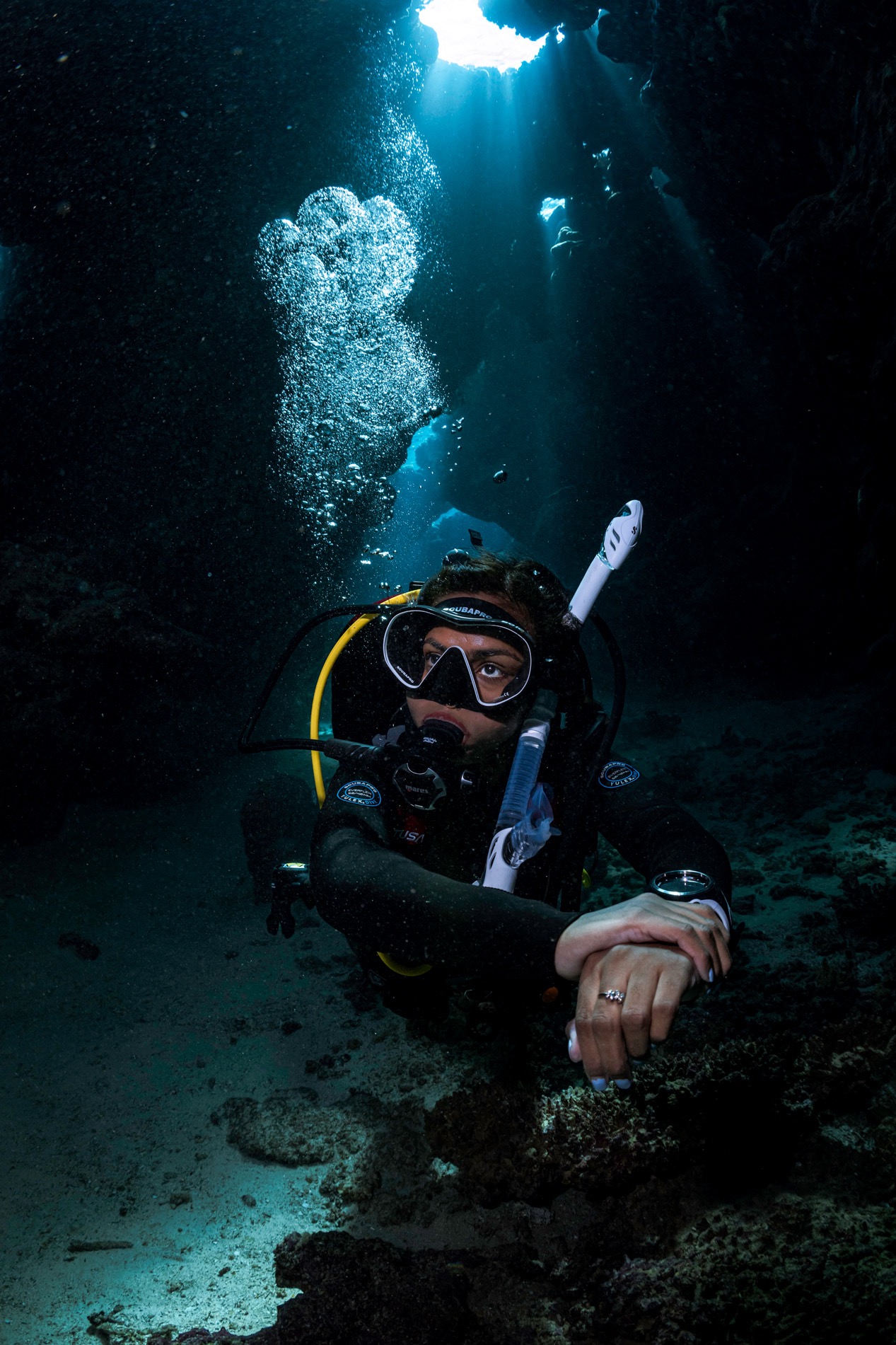 scuba diver in dark crevass
