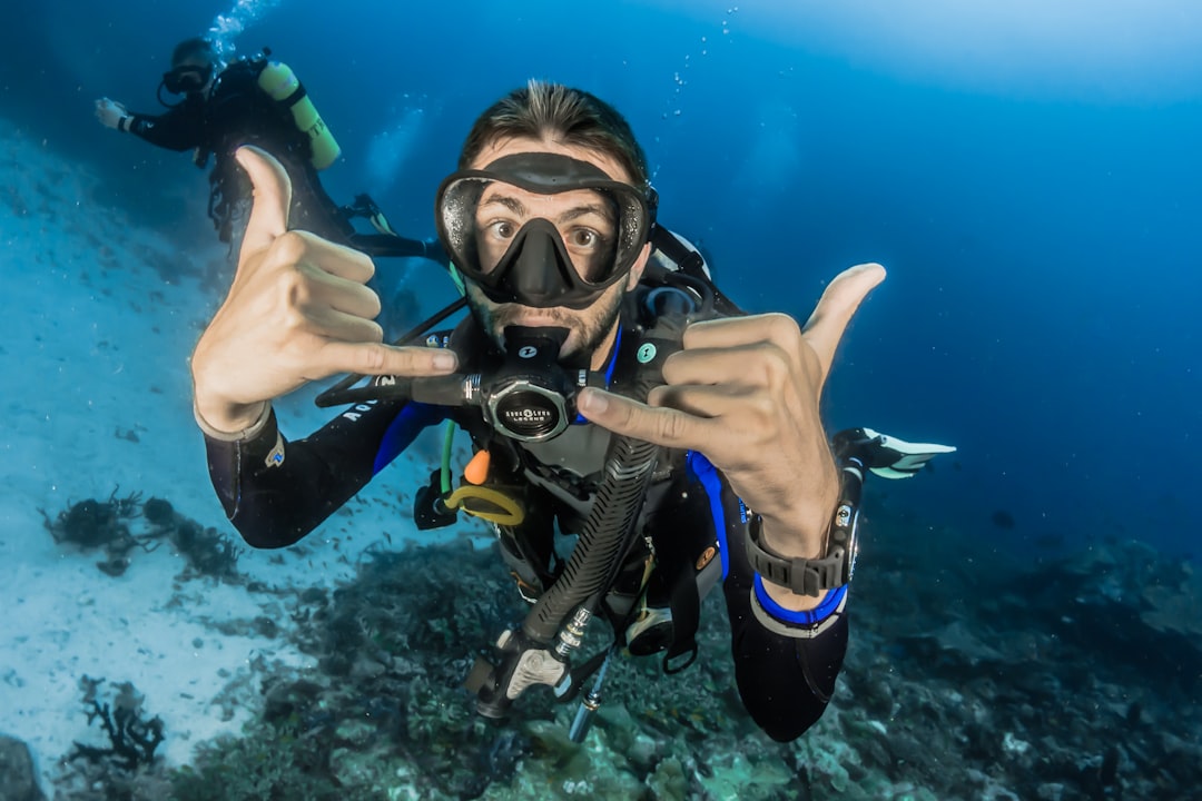 happy diver underwater giving hand signs for awesome