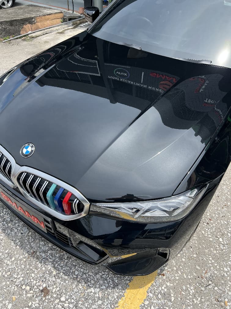 PPF film applied on glossy black sedan
