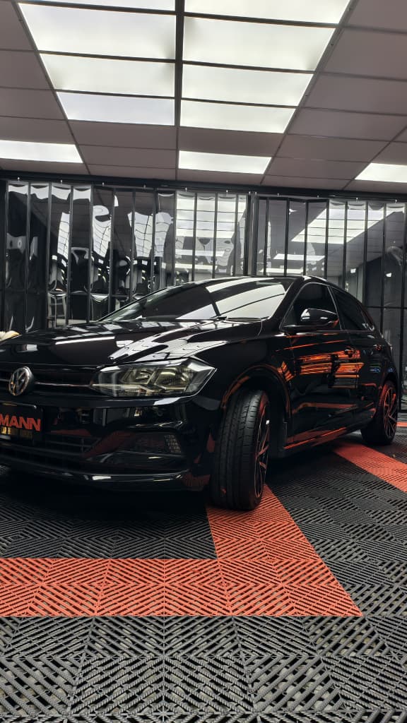 Black car ceramic coated under showroom light