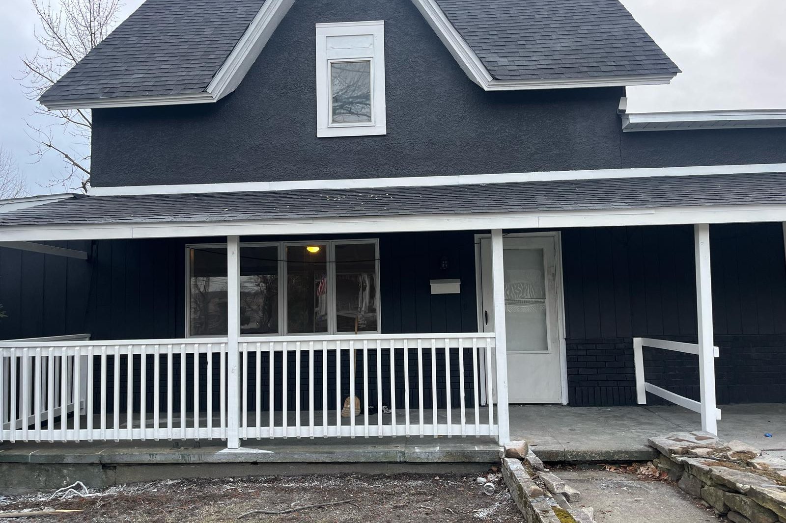 The rebuilt porch at 340 N Main Street, Old Forge: new white balustrade, repainted boarding and new steps.