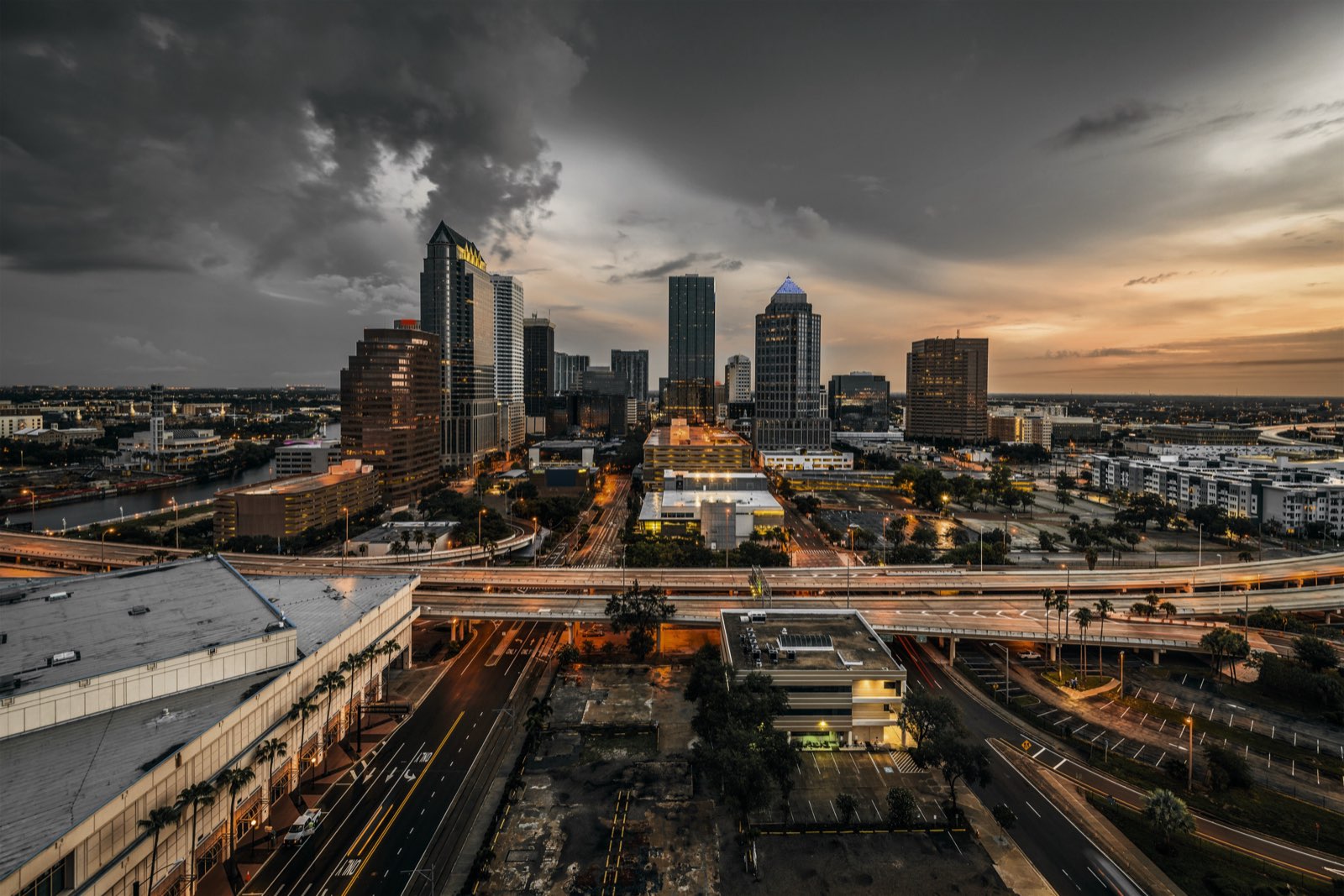 Downtown Tampa skyline at dusk under storm clouds