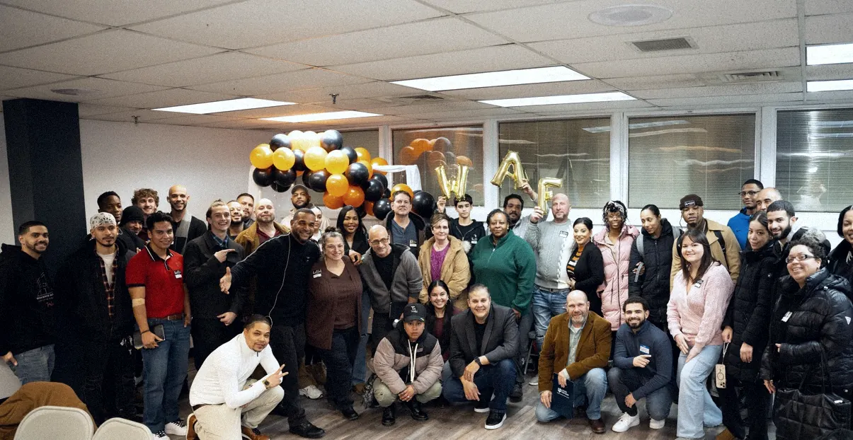 Elite Strategies Consulting members gathered for a group photo at a live event