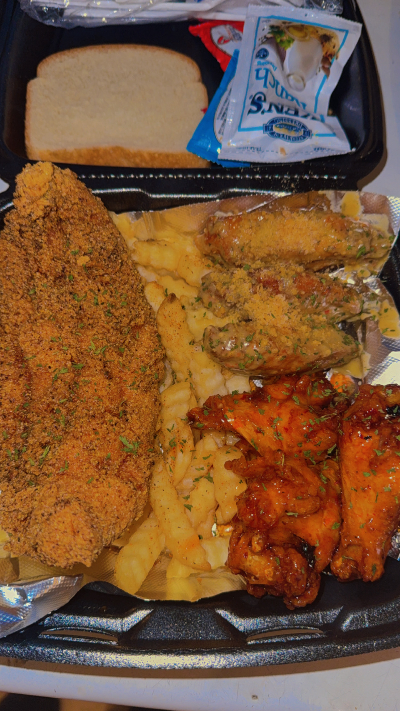 Greedy Gang Wednesday meal with fish, wings, fries, and sides