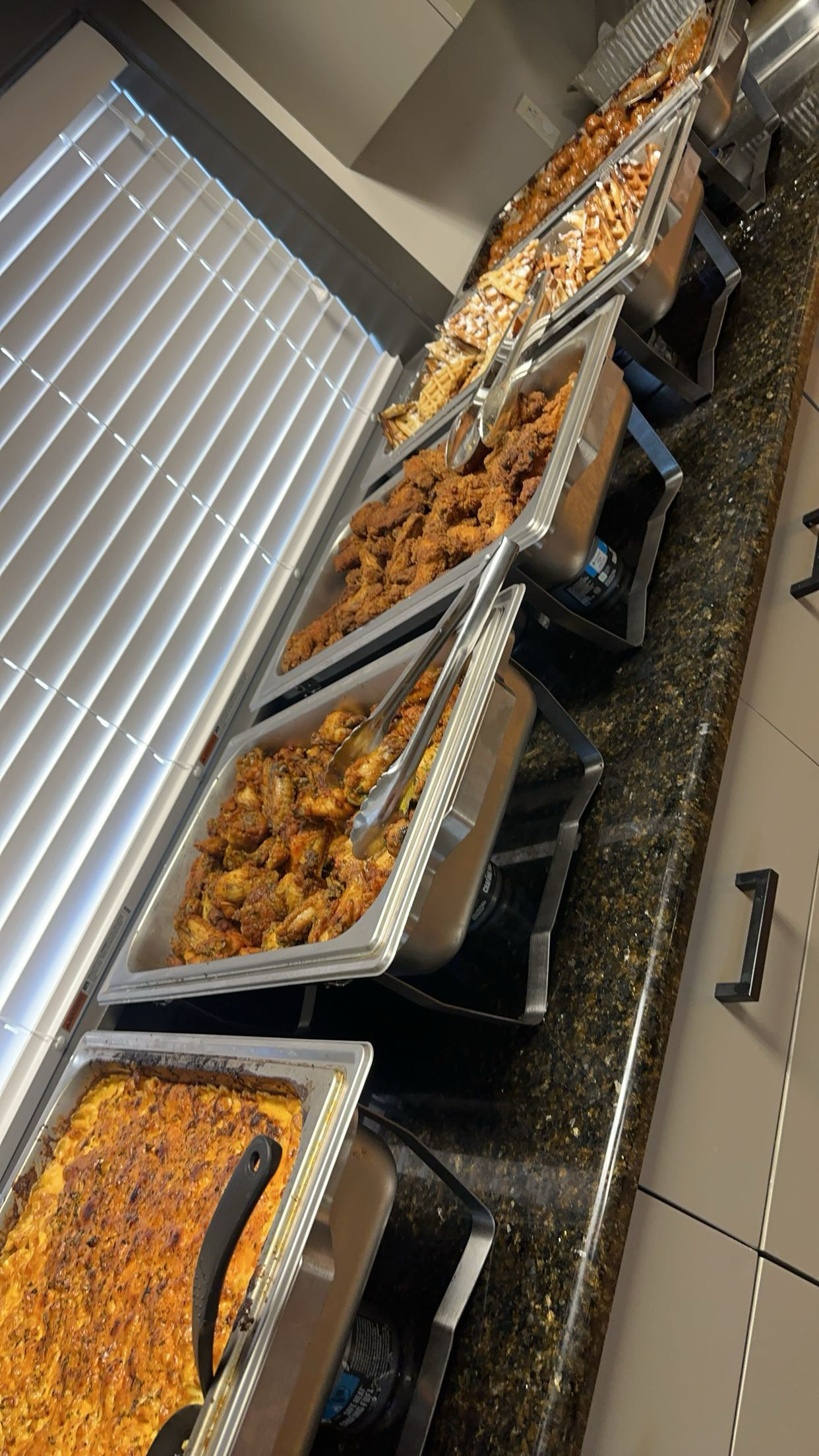 Greedy Gang trays of chicken, pasta, and sides