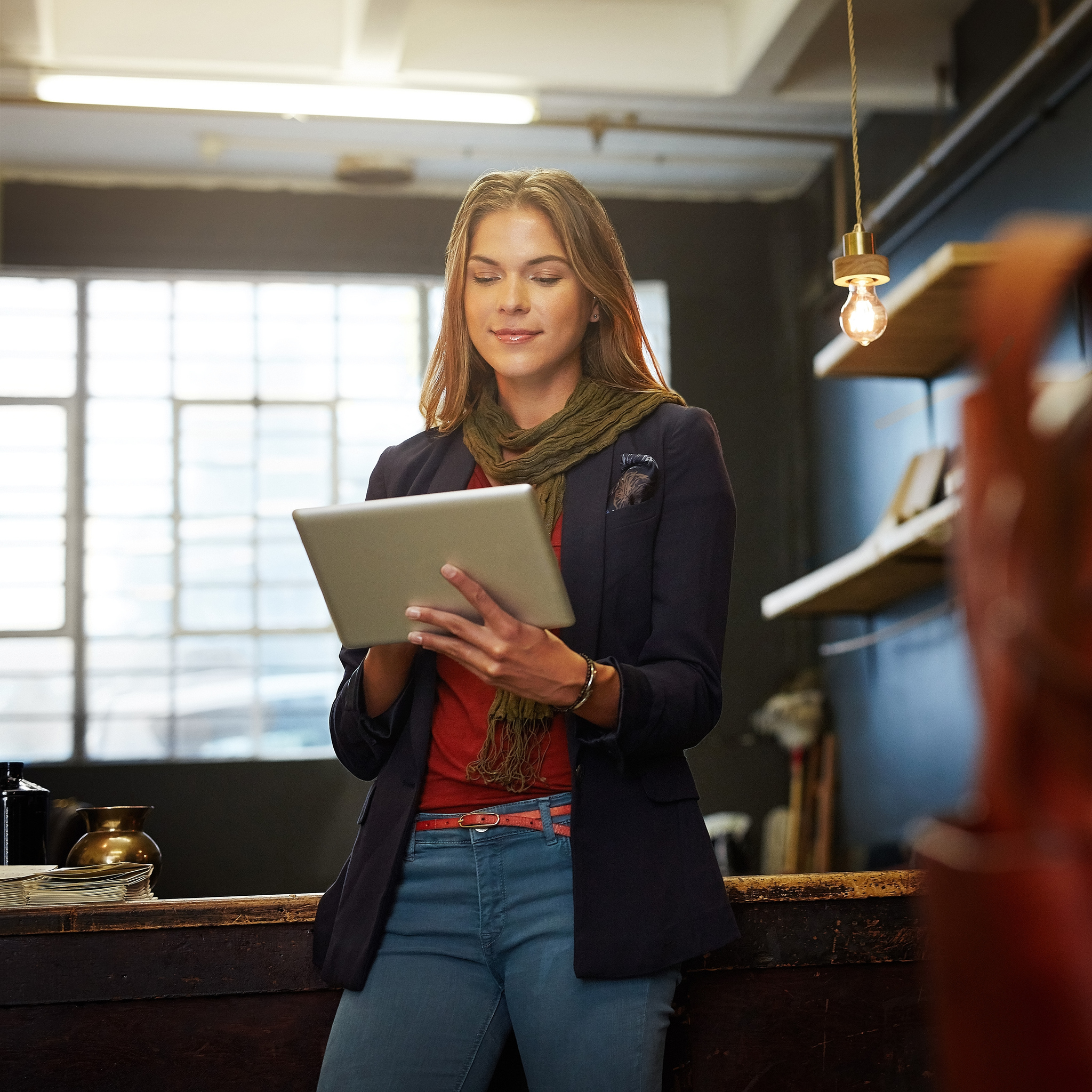 Small business owner using a tablet in a clothing studio