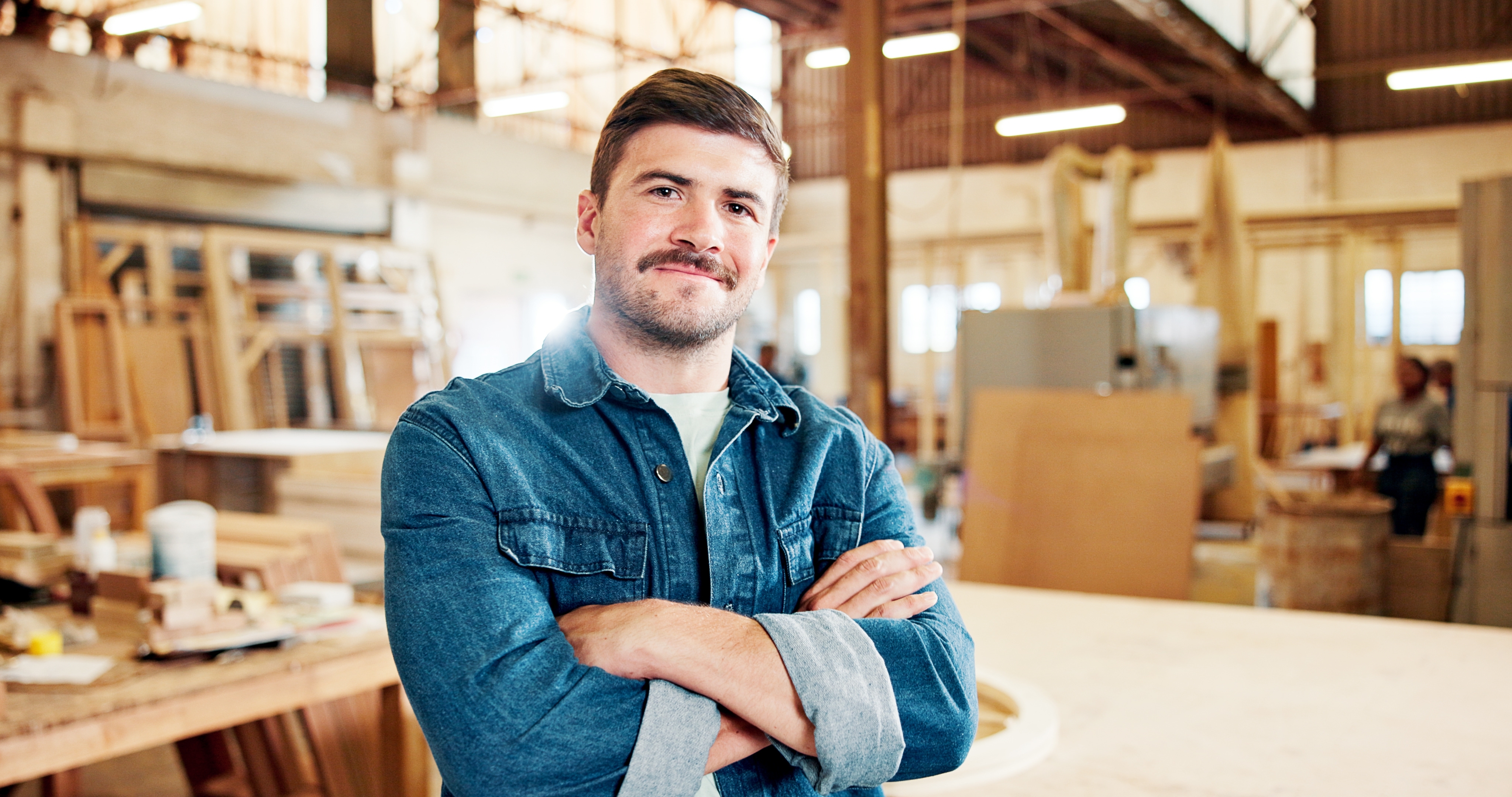 Carpenter standing in a woodworking workshop