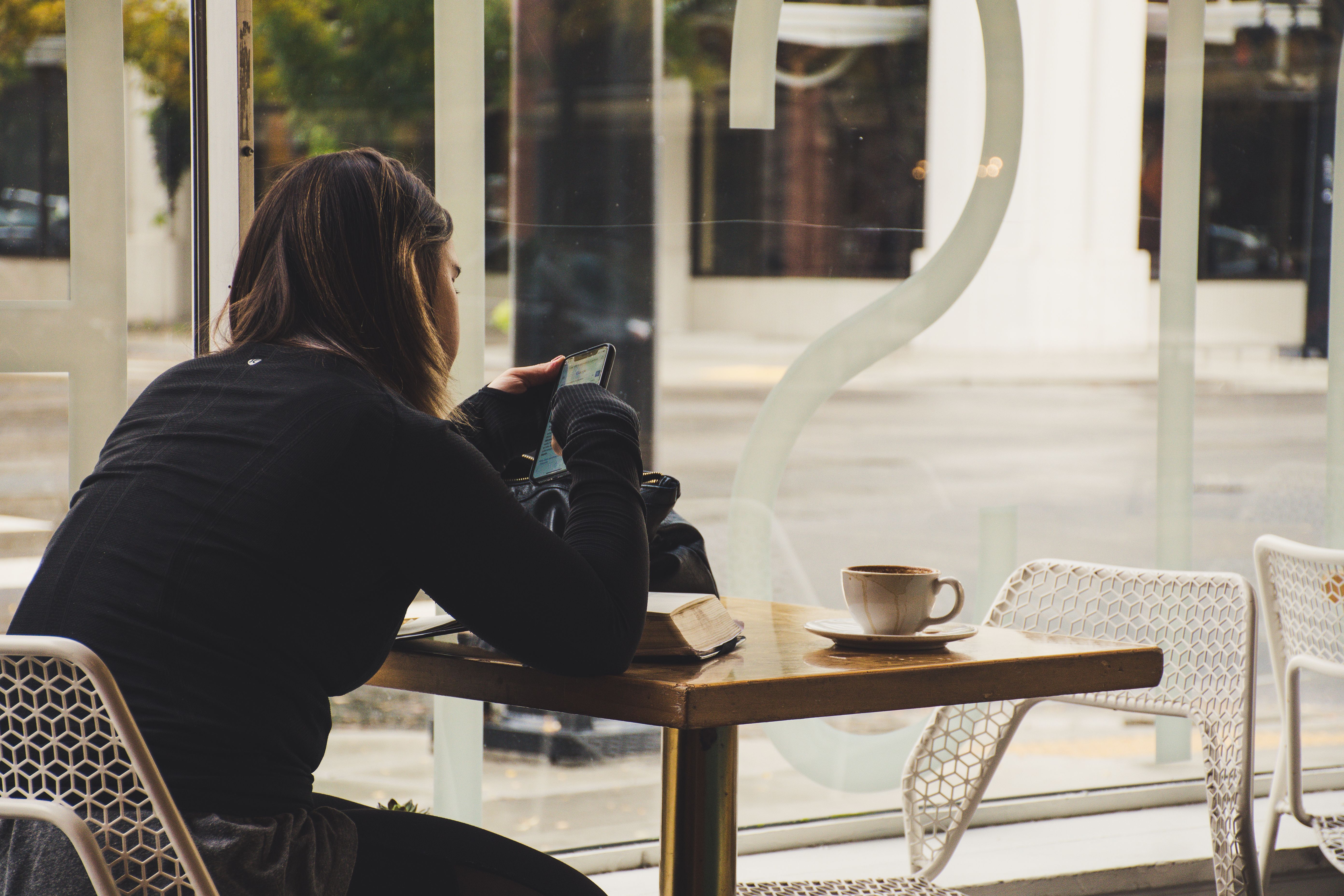 Woman using her smartphone at a café table