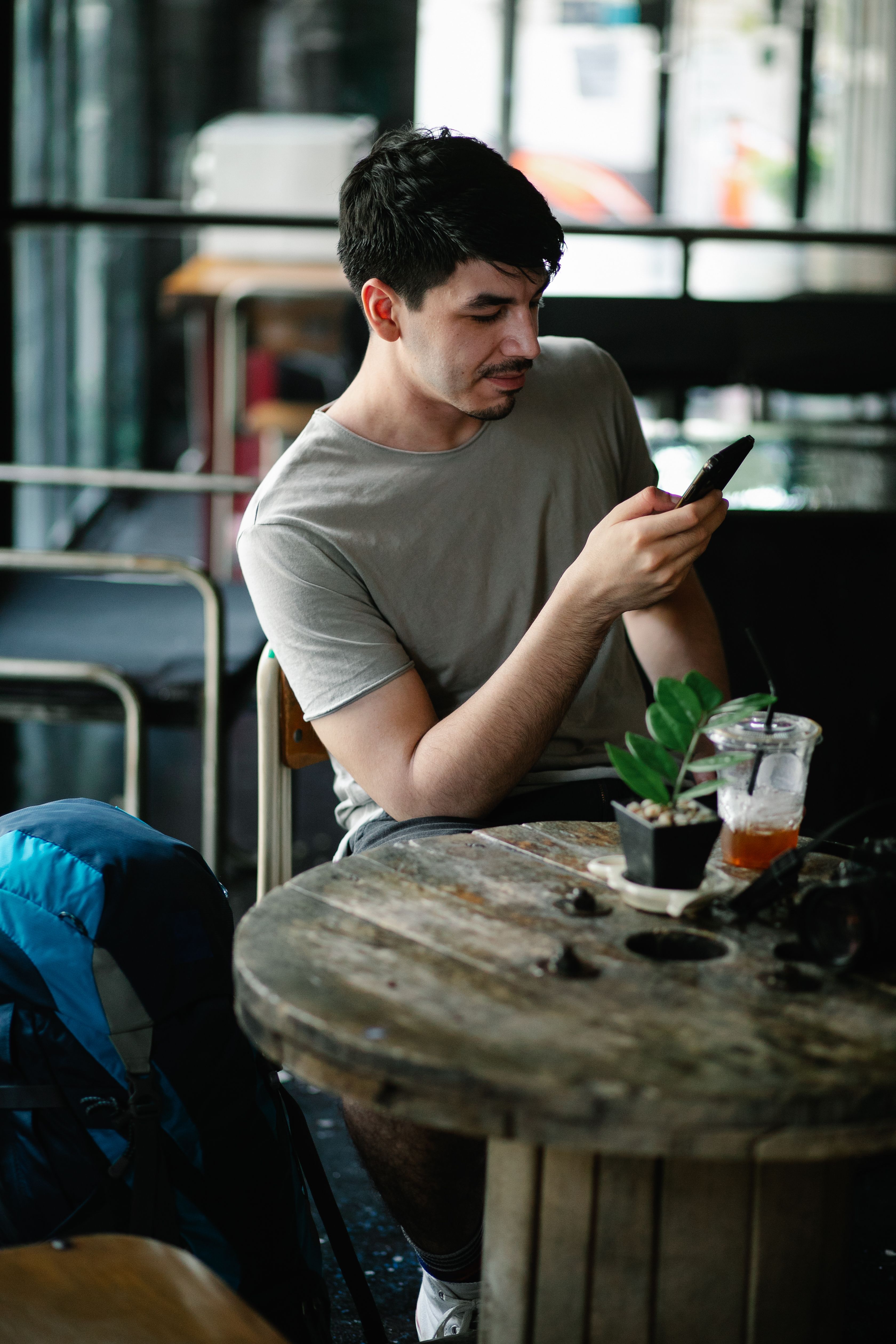 A customer browsing a smartphone at a café
