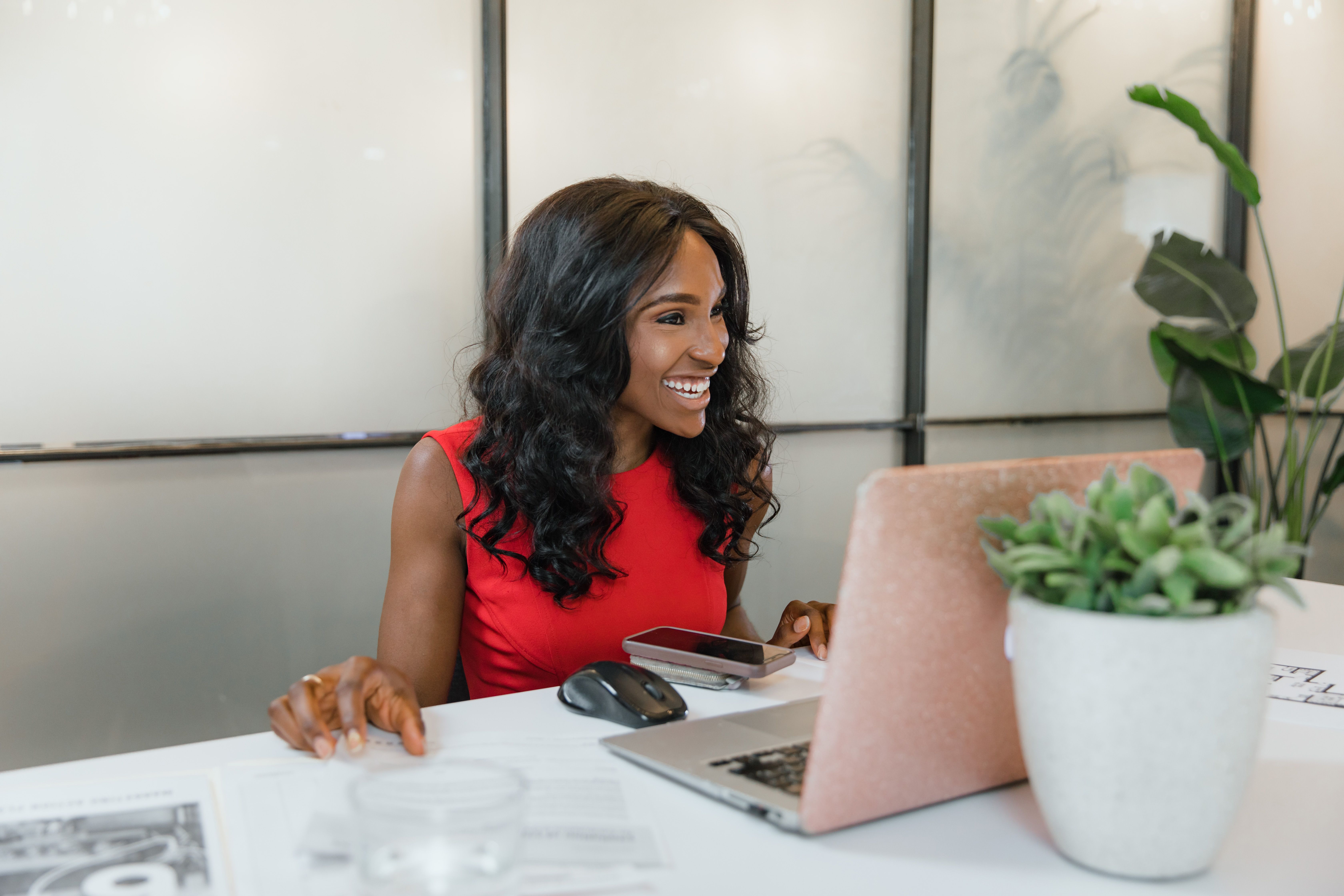 Woman using a laptop at a bright desk
