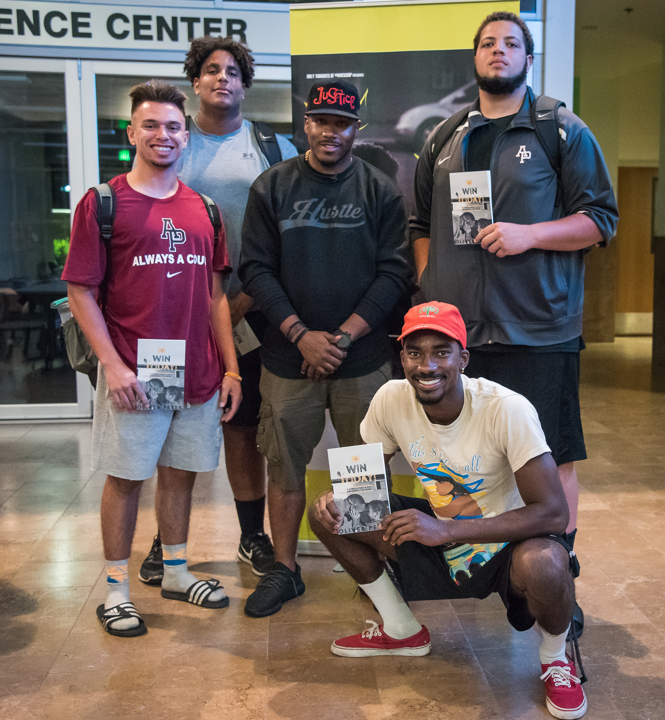 Students holding Win Today books