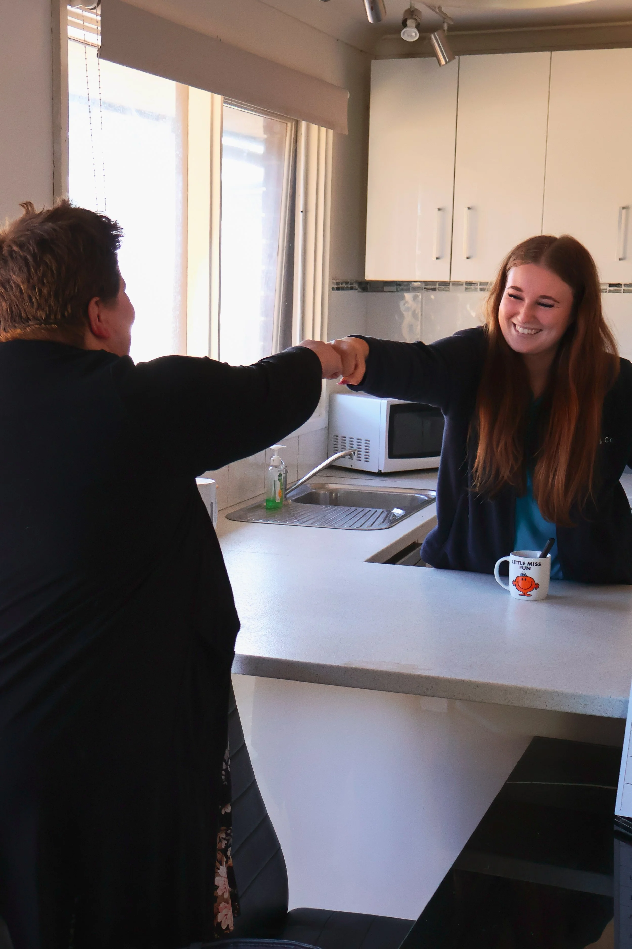 Paris and Dora share a moment in the kitchen at our Cranbourne home