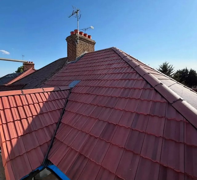 New red roof tiles across a hip and valley