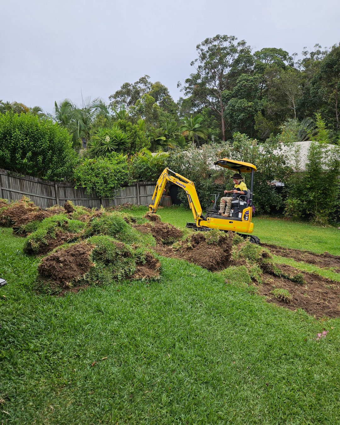 Mini excavator trenching