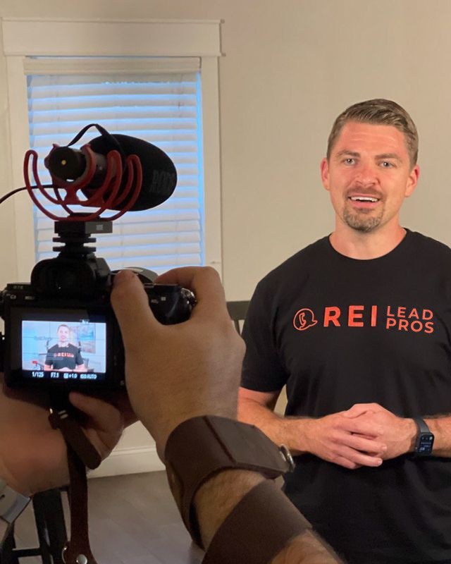 Anton being filmed on camera in an REI Lead Pros t-shirt