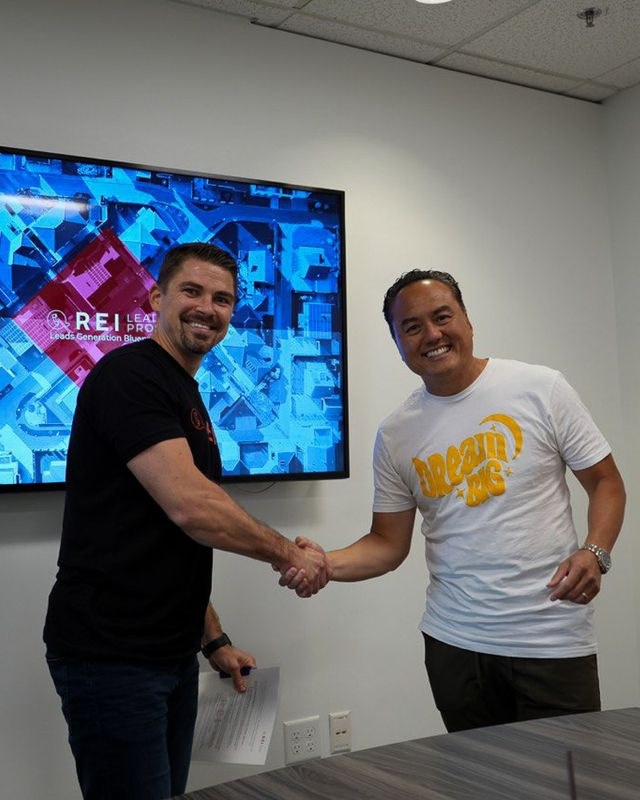 Anton shaking hands with a man in the REI office