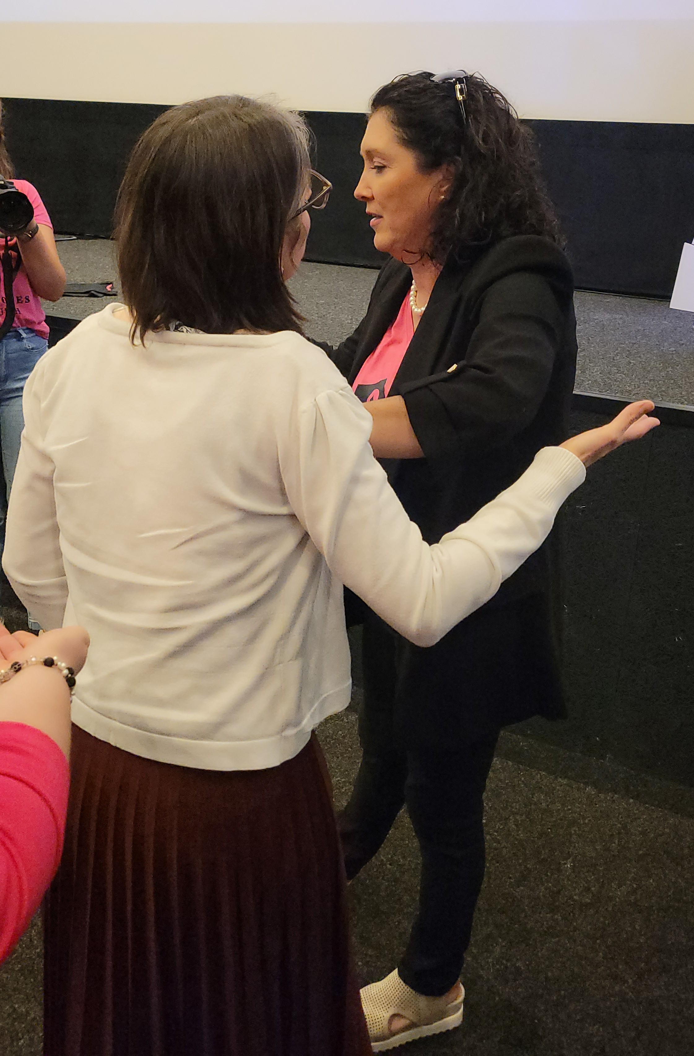 Mary Malone ministering to a woman at the end of session 7 of the June 2025 She Loves ruth Conference