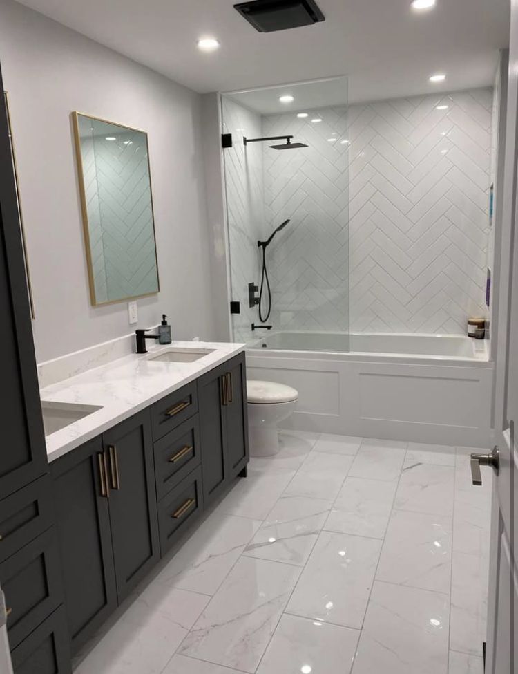 Bathroom remodel featuring updated vanity, tile, and fixtures