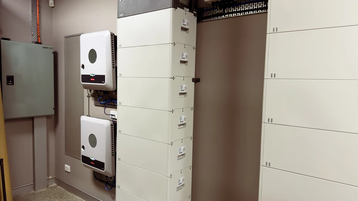 Hybrid inverters beside battery cabinets