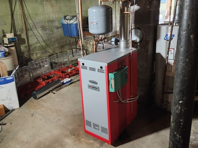 High-efficiency boiler system installed in a basement, providing reliable hot water and heating.