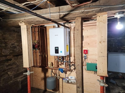 Tankless water heater system installed in a basement, optimized for efficient hot water supply.