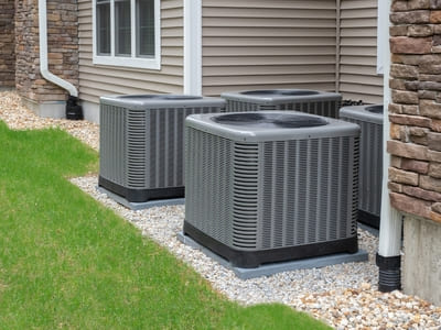 Multiple heat pump units installed outside a residential building, offering efficient climate control.