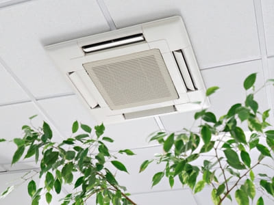 Ceiling-mounted air conditioning unit in an office setting, designed for optimal air distribution and cooling.