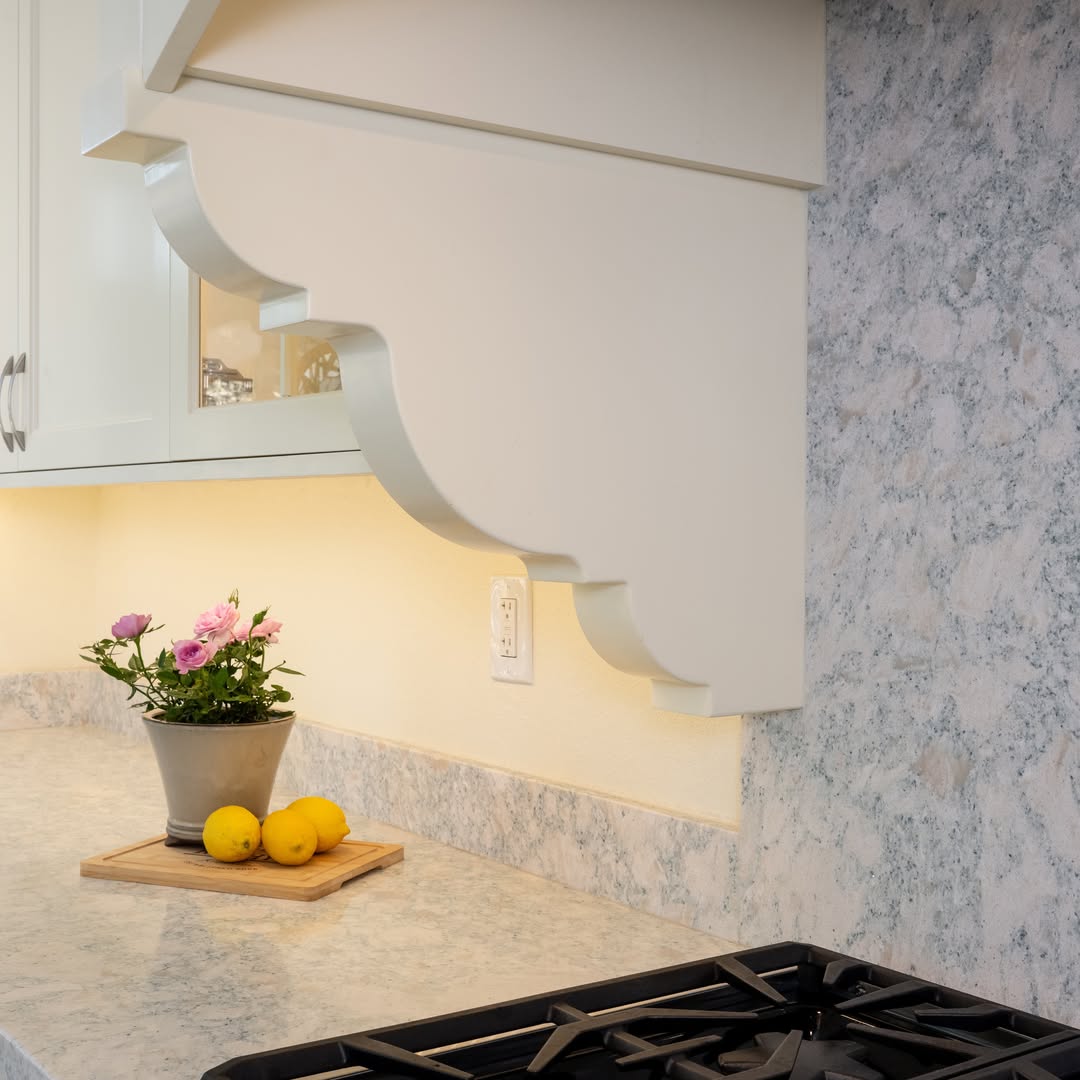 Custom carved corbel and marble backsplash detail — Niche Construction