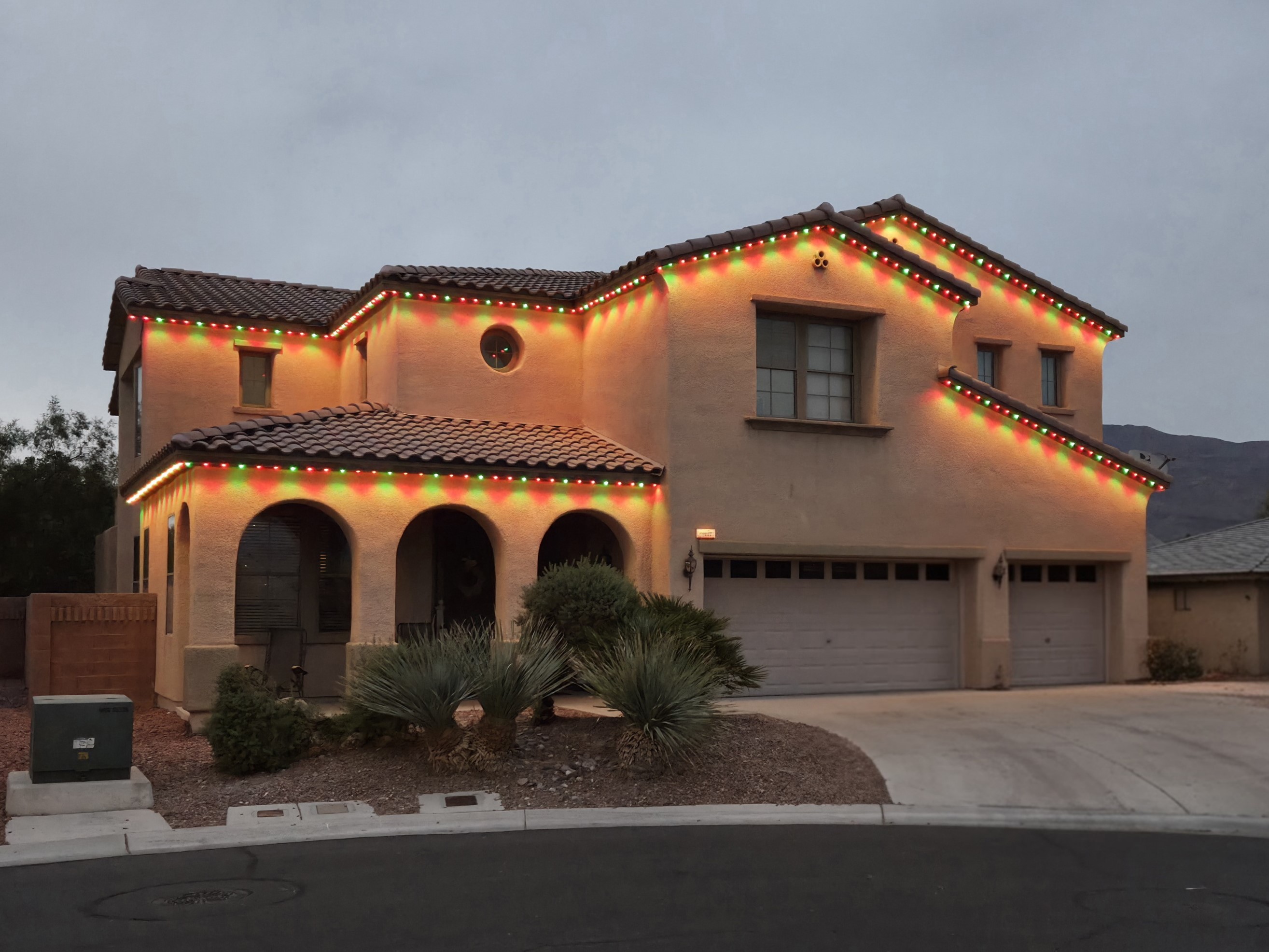 Las Vegas home with permanent roofline lights in holiday colors at night