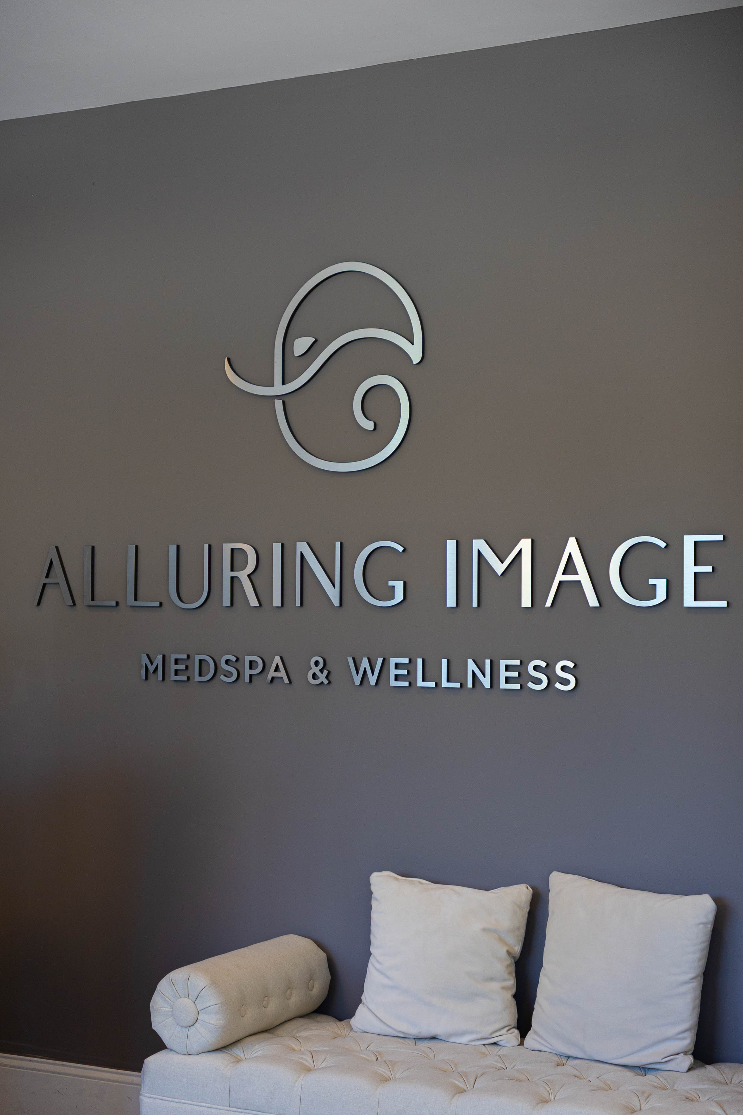 Clean, professional medical spa treatment room with neutral tones at Alluring Image Medspa and Wellness in Delray Beach
