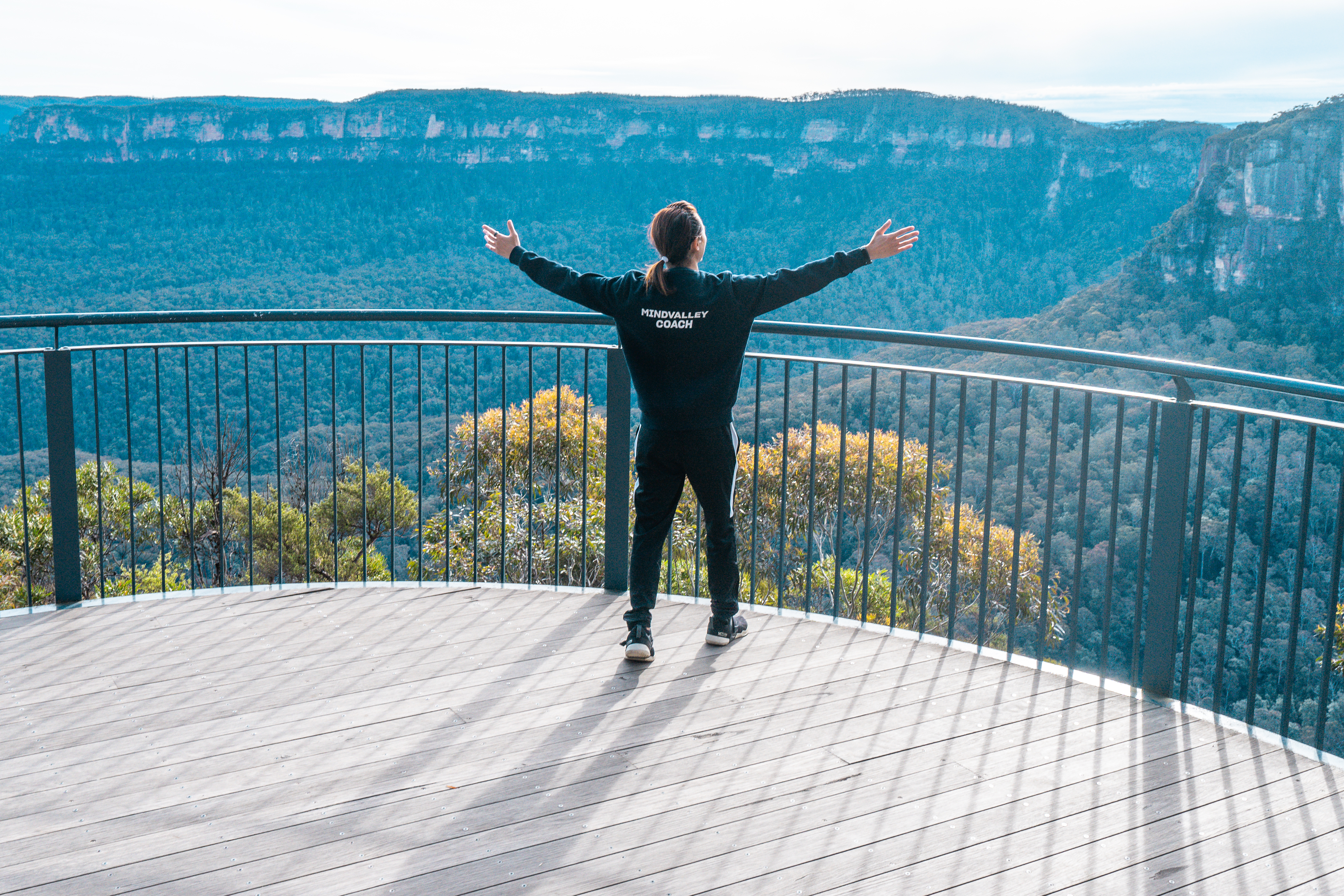 Freeman Fung, celebratory pose facing the Sydney mountain