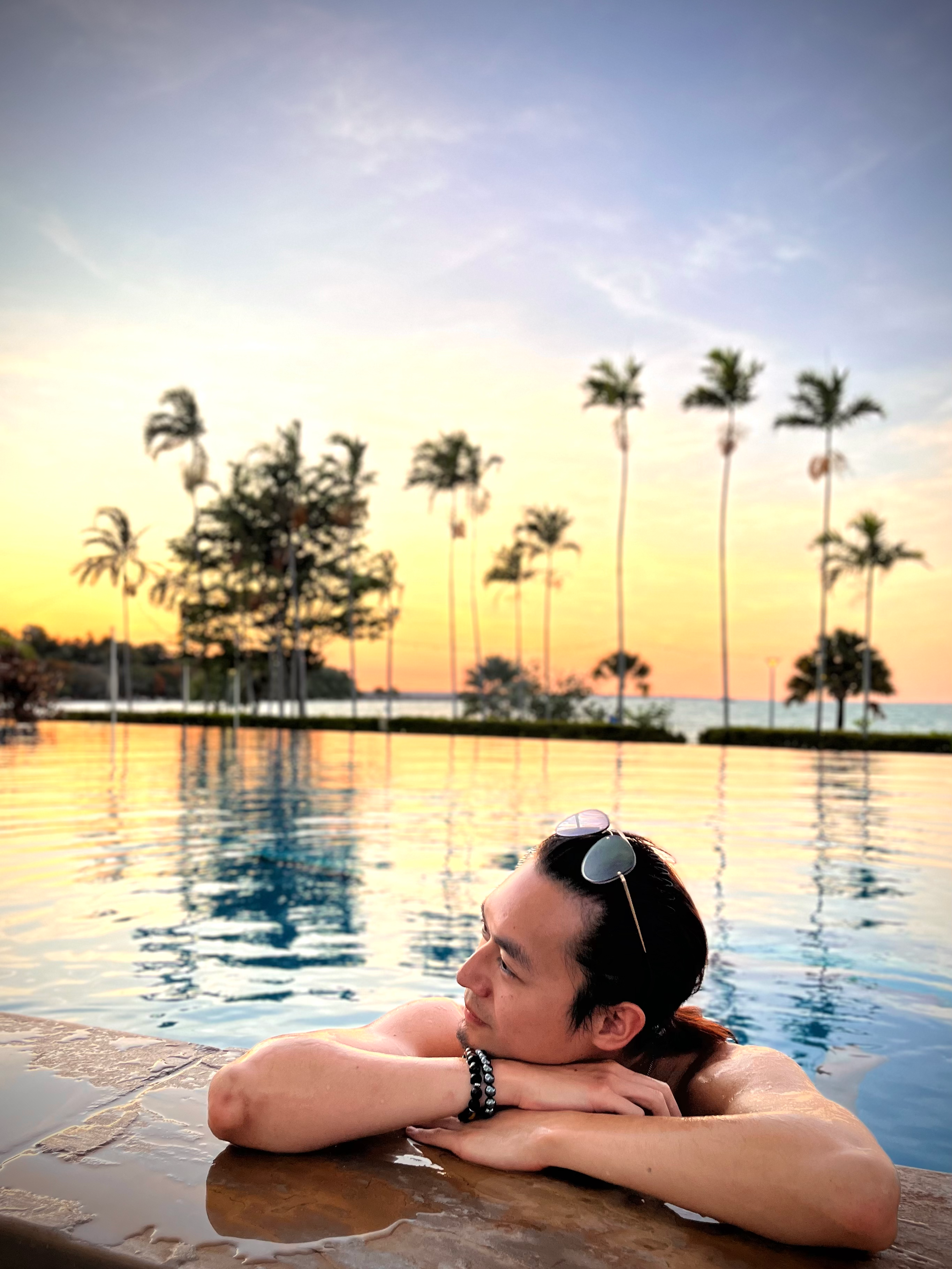 Freeman Fung relaxing on the edge of a pool