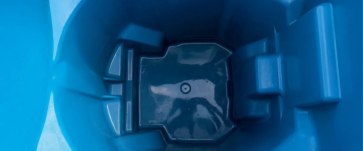 A top-down view inside a clean royal blue plastic container with a textured bottom.