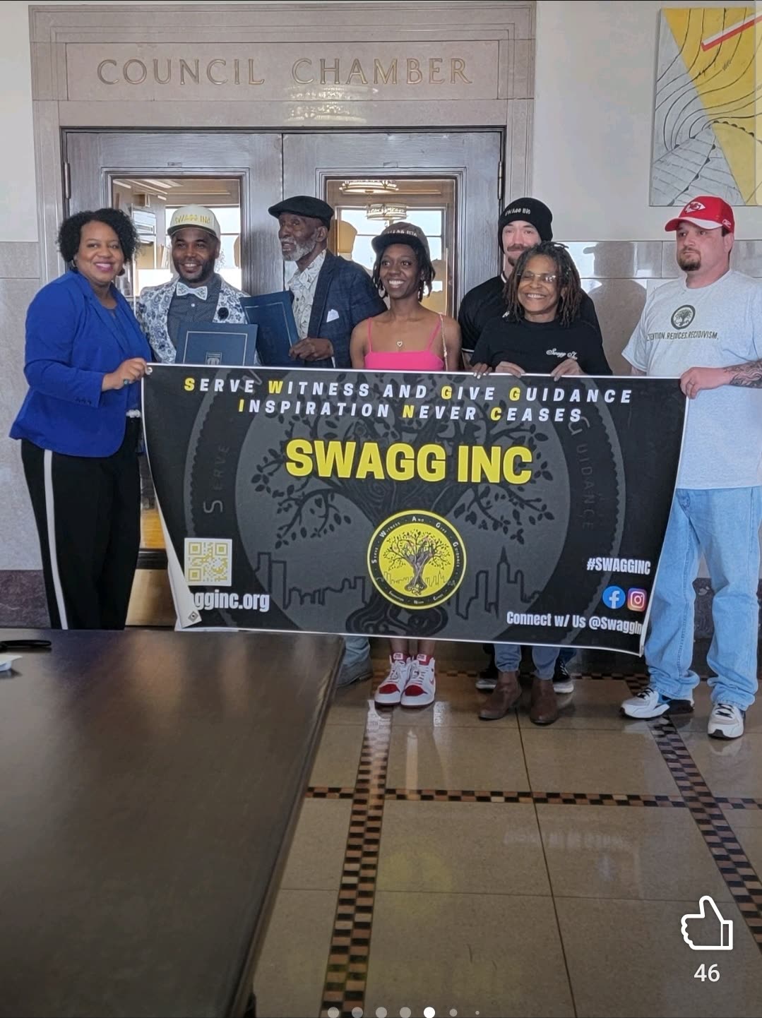 Swagg Inc. team with banner in a council chamber