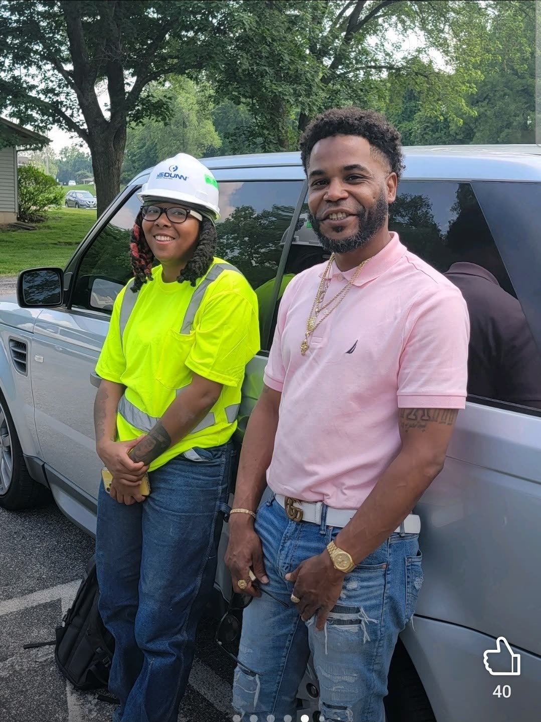 Na'im with a construction worker in a hard hat