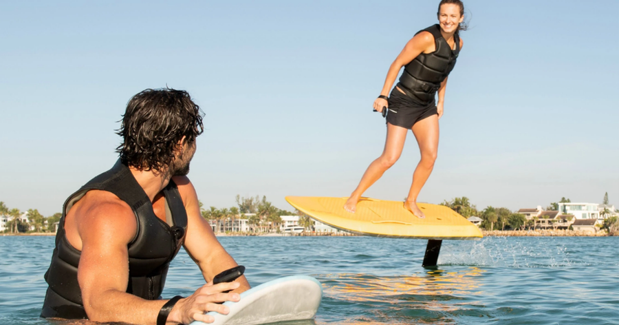 Experience the feeling of flight: A couple gliding effortlessly on eFoils, the ultimate in silent, zero-emission water sports.