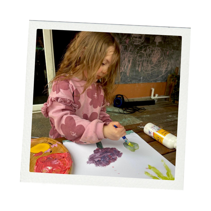child painting in childcare