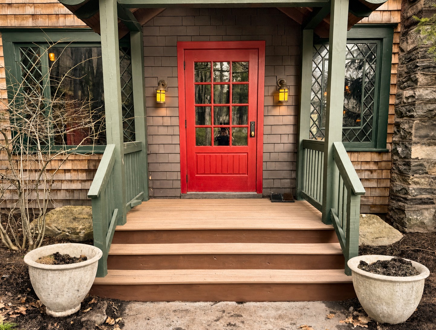 TimberTech covered entry with refinished and weatherproofed red front door