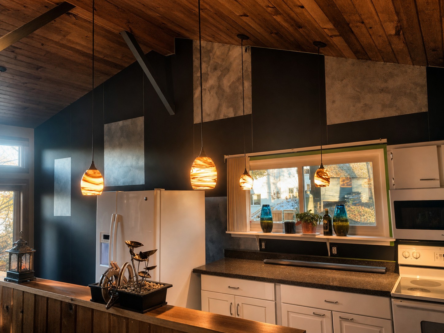 Full kitchen renovation with vaulted wood ceiling and picture framed silver brush accent wall