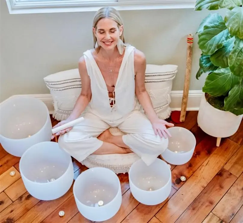 Sandra seated with crystal singing bowls